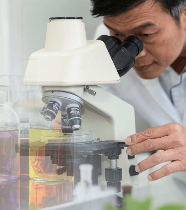 Scientist using a microscope in a laboratory